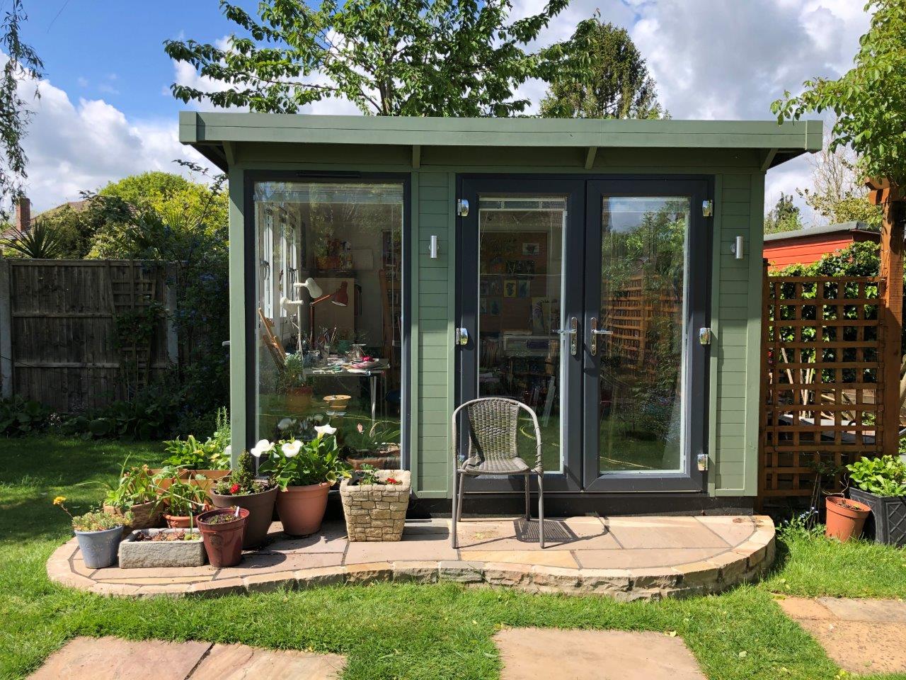 Garden studio with small patio outside.