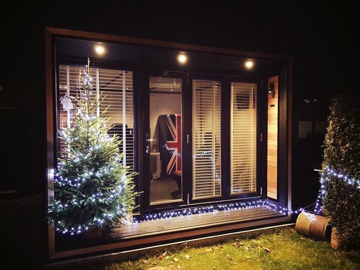 Ultra office with christmas tree outside.
